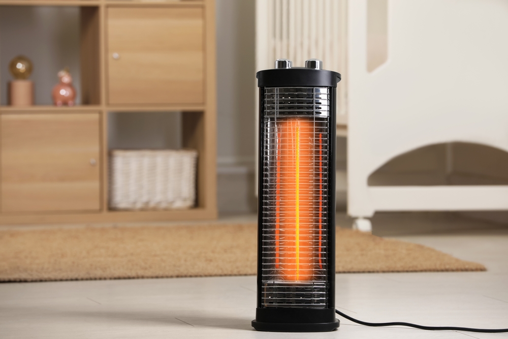 Modern infrared heater on floor in cozy room.