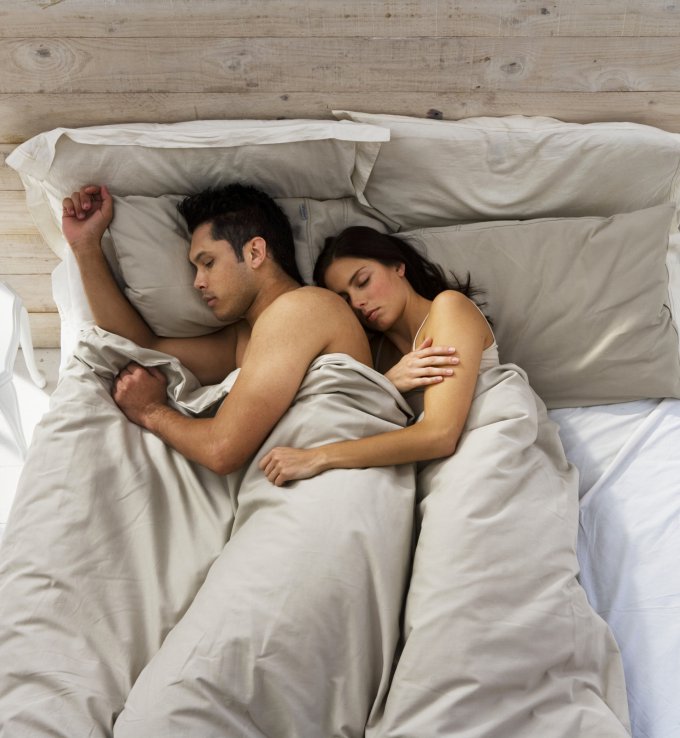 Illustration douce d'un couple dormant l'un derrière l'autre, dans une ambiance paisible