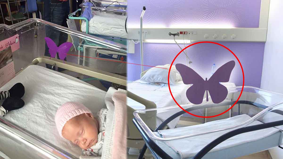 Autocollant papillon violet sur un berceau de maternité