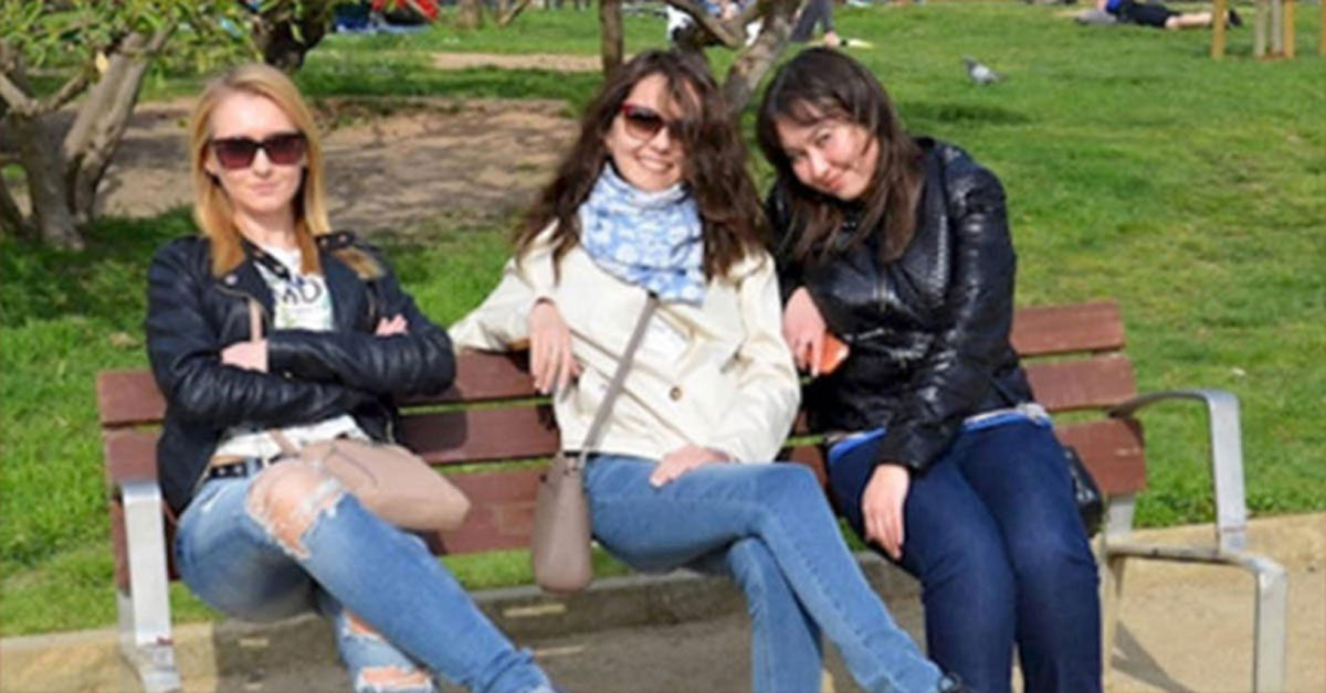 Trois femmes souriantes posant ensemble