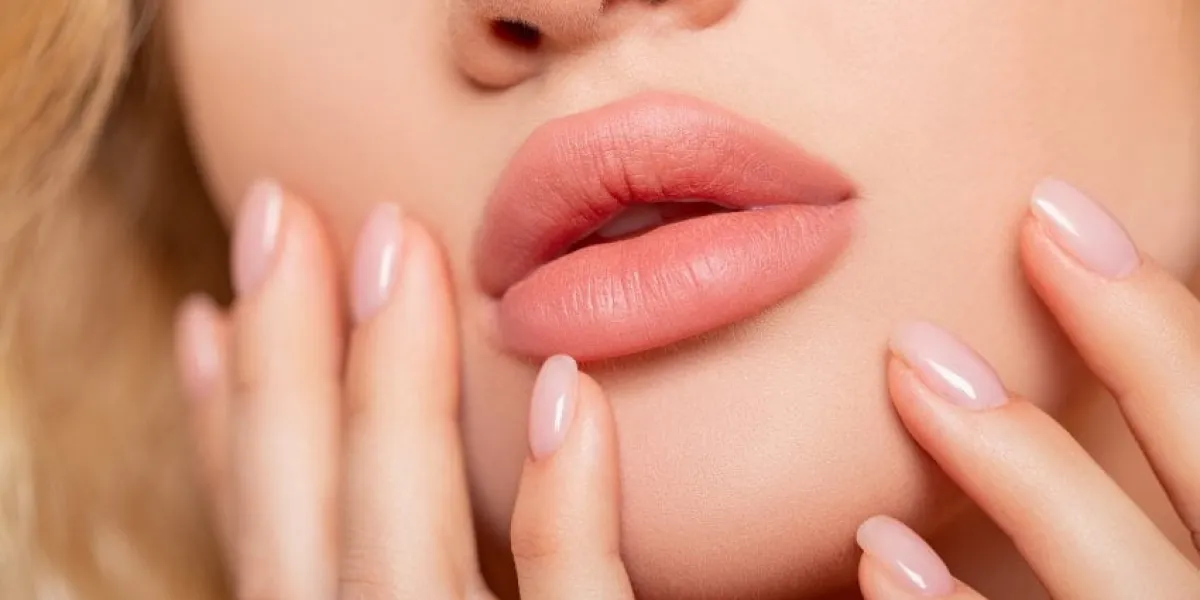 Gros plan sur une femme appliquant un soin pour les lèvres